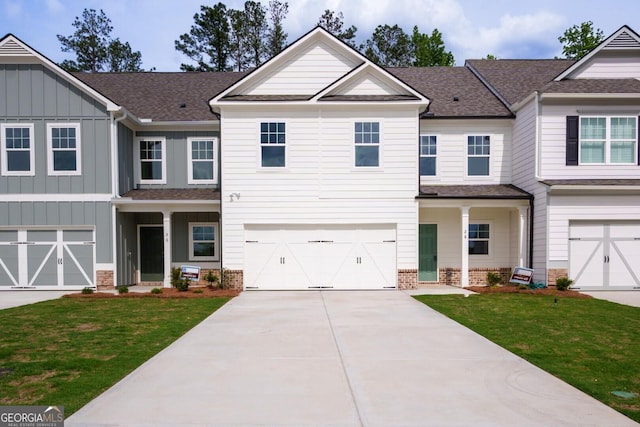 28 Russet Way Lot 60, Newnan, GA 30263 - view of front facade featuring concrete driveway, a front yard, board and batten siding, and an attached garage