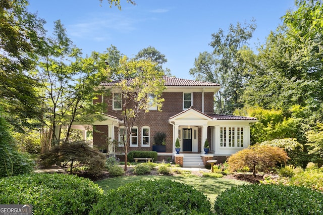 mediterranean / spanish home with a front yard