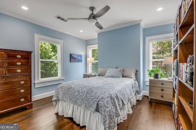 bedroom with ceiling fan, dark wood-type flooring, ornamental molding, and multiple windows