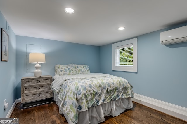 bedroom featuring dark hardwood / wood-style floors and a wall mounted air conditioner