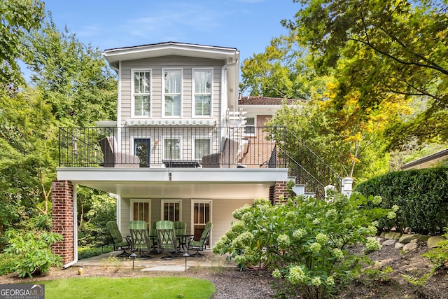 back of house with a balcony and a patio