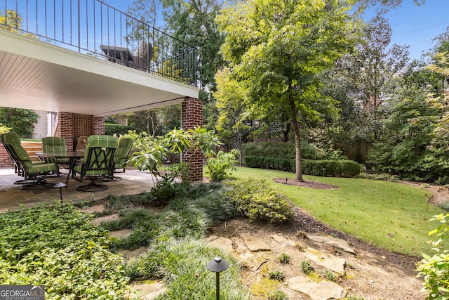 view of yard featuring a patio area and a balcony