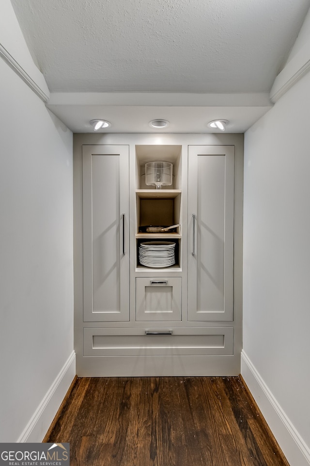 interior details with a textured ceiling and dark hardwood / wood-style flooring