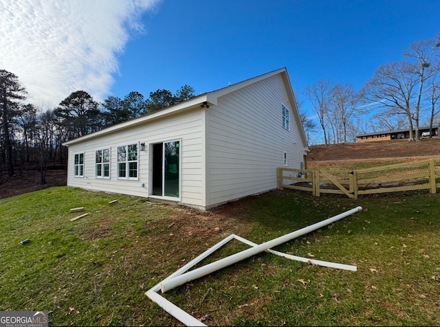 view of property exterior with a lawn