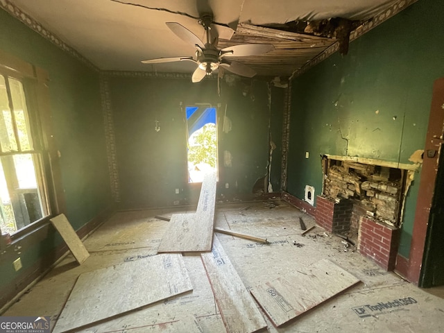 miscellaneous room featuring ceiling fan and a fireplace