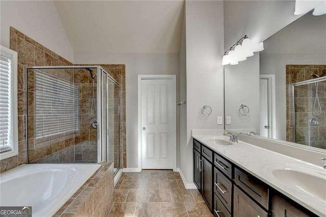 bathroom with vaulted ceiling, separate shower and tub, and vanity