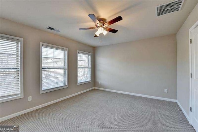 carpeted spare room featuring ceiling fan