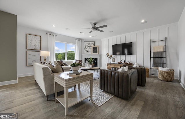 living room featuring ceiling fan and wood-type flooring