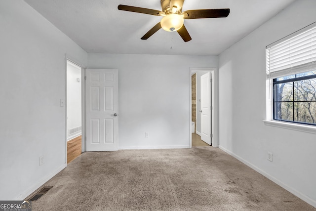 carpeted empty room with ceiling fan