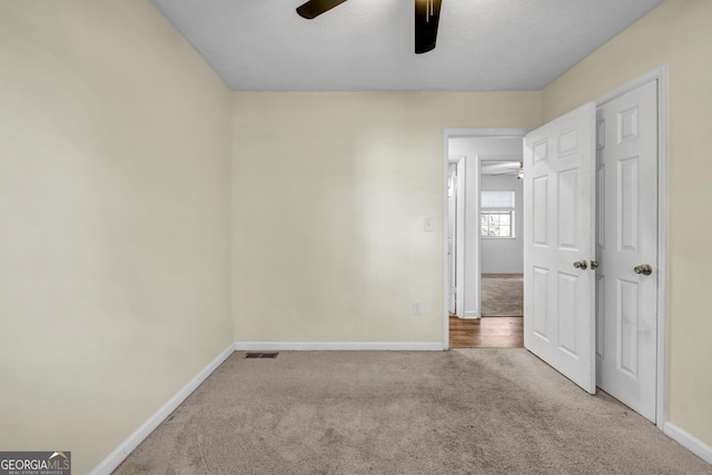 carpeted empty room with ceiling fan