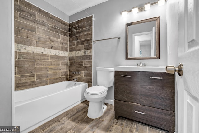 full bathroom with wood-type flooring, toilet, vanity, and tiled shower / bath