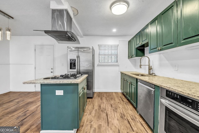 kitchen featuring ventilation hood, appliances with stainless steel finishes, sink, and green cabinetry