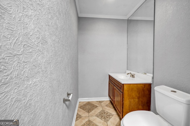 bathroom featuring ornamental molding, toilet, tile patterned flooring, and vanity