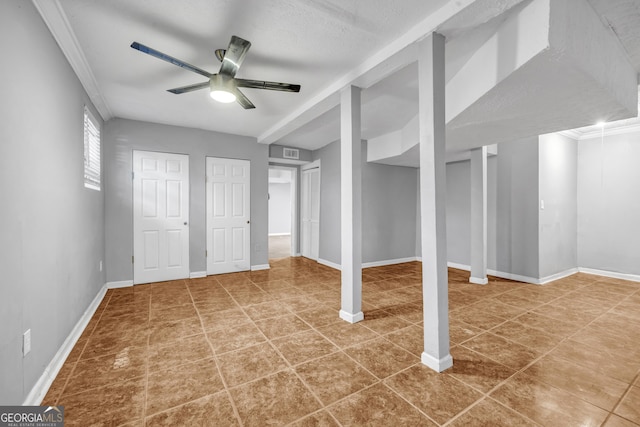 basement with ceiling fan and tile patterned flooring