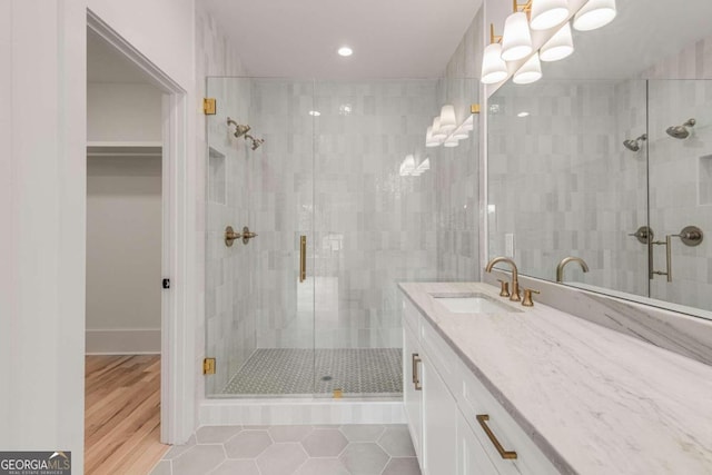 bathroom featuring walk in shower, vanity, and tile patterned flooring