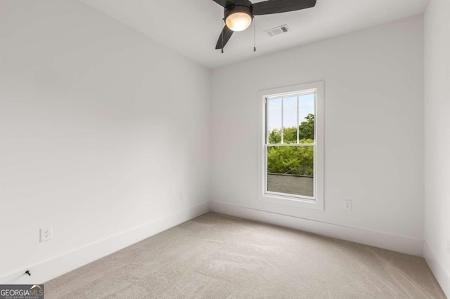 carpeted spare room with ceiling fan