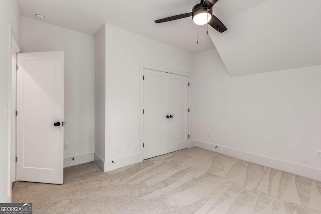 additional living space featuring vaulted ceiling, ceiling fan, and light colored carpet