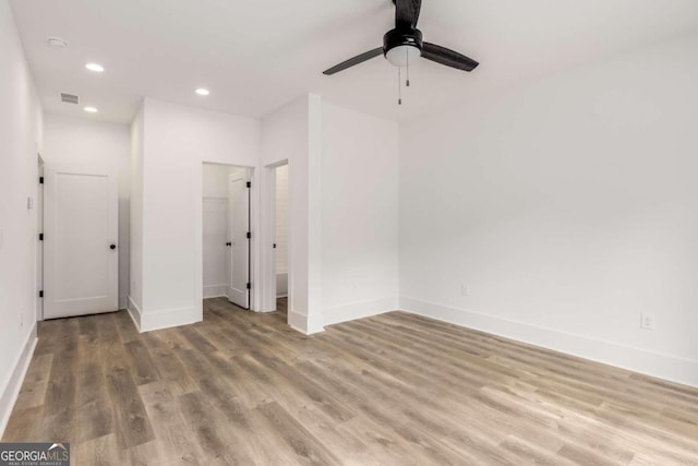 spare room featuring ceiling fan and light hardwood / wood-style flooring