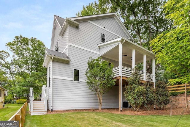 view of property exterior featuring ceiling fan and a yard