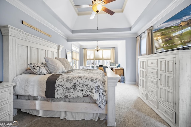 carpeted bedroom featuring a tray ceiling, ceiling fan with notable chandelier, and ornamental molding