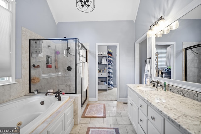 bathroom with independent shower and bath, vanity, lofted ceiling, and tile patterned floors