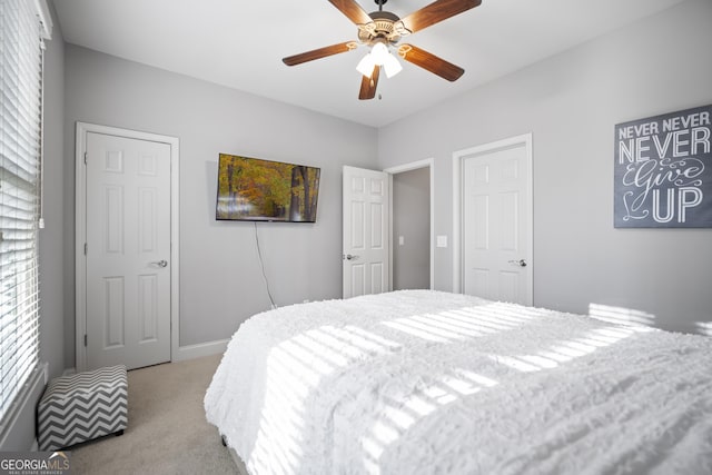 bedroom featuring ceiling fan and light carpet