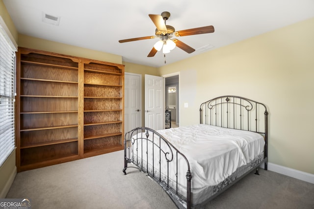 carpeted bedroom with multiple windows and ceiling fan