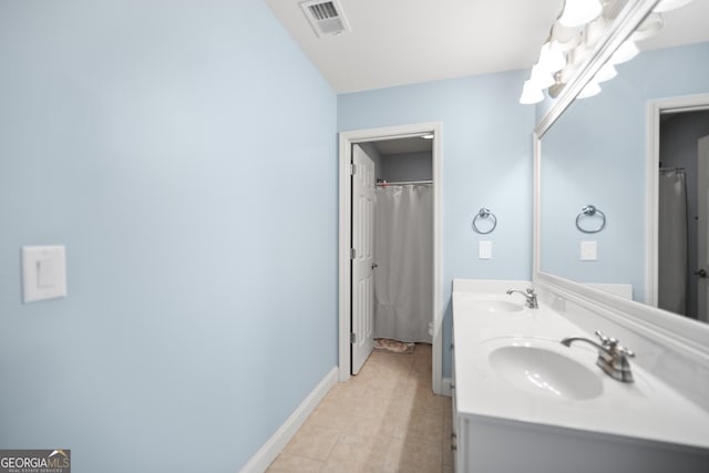 bathroom with tile patterned flooring and vanity