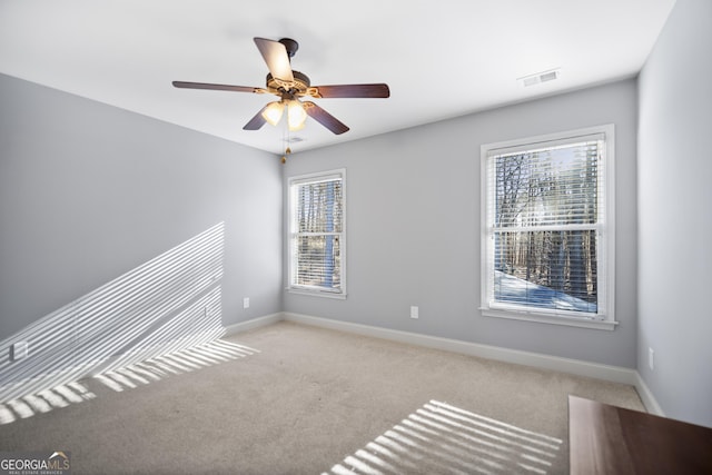 unfurnished room with ceiling fan and light carpet