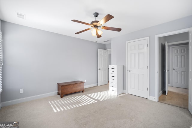 unfurnished bedroom with light carpet and ceiling fan