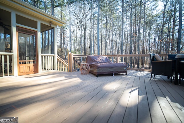 wooden deck with a sunroom