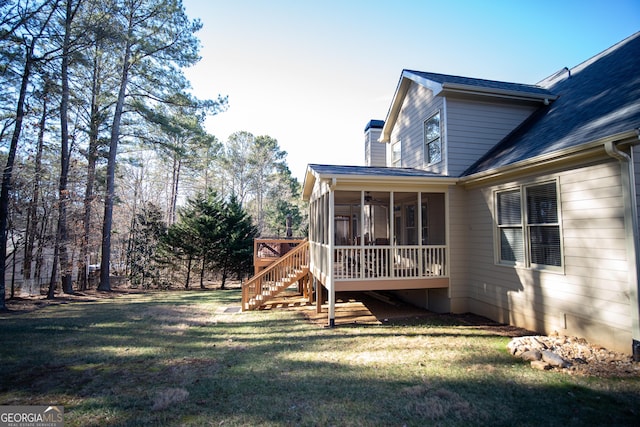 view of yard featuring a sunroom