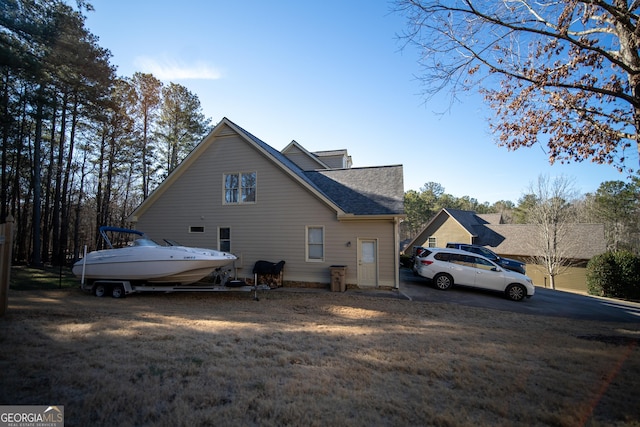 view of property exterior with a lawn