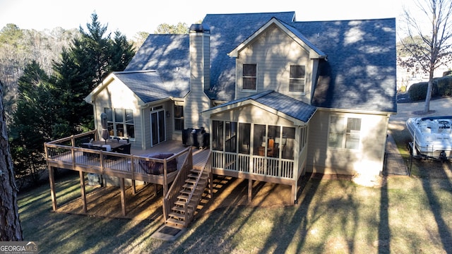 back of property with a sunroom and a deck