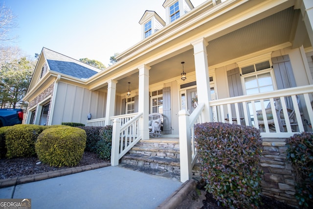 view of exterior entry with a porch