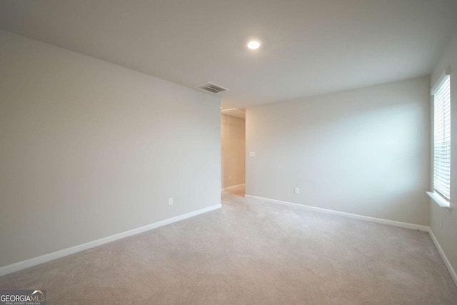 empty room with light colored carpet