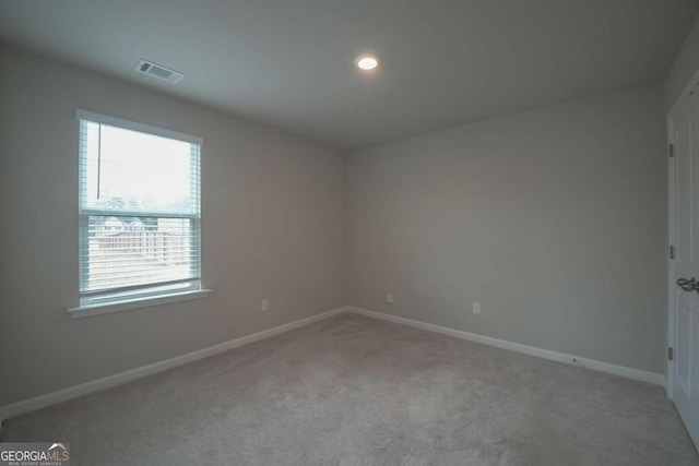 spare room with light colored carpet