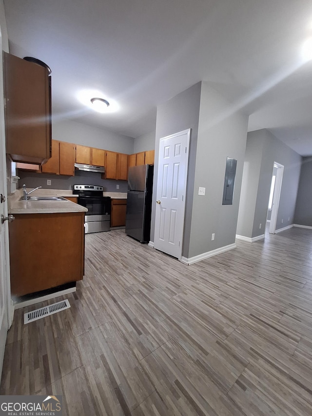 kitchen with stainless steel appliances, light hardwood / wood-style floors, and sink