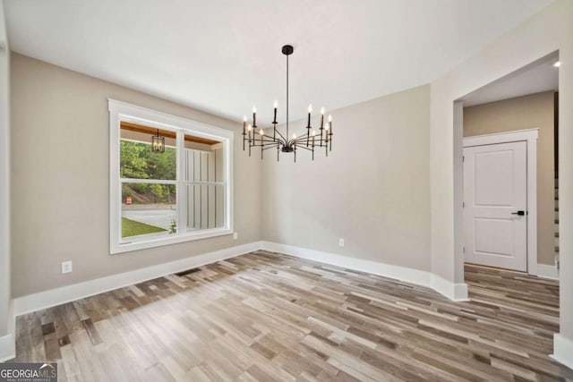220 Autumn Brook Dr, Canton, GA 30115 - unfurnished dining area featuring a chandelier and wood finished floors