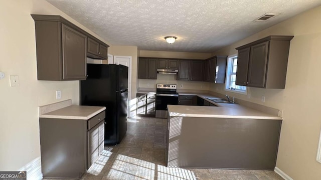 kitchen with sink, electric range, black fridge, and a textured ceiling