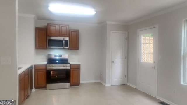 kitchen with ornamental molding and stainless steel appliances