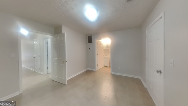 spare room featuring a textured ceiling