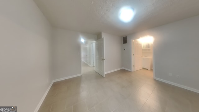 spare room featuring a textured ceiling