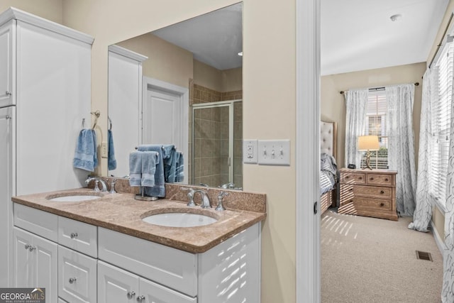 bathroom with an enclosed shower and vanity