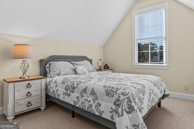 carpeted bedroom with lofted ceiling