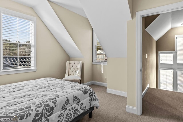 bedroom with lofted ceiling and light carpet