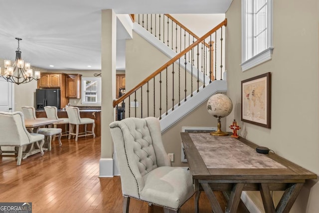 interior space with an inviting chandelier and light hardwood / wood-style floors