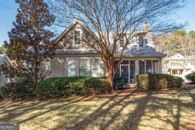 view of property with a front yard and a sunroom