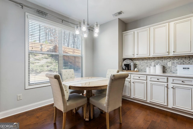 dining space featuring dark hardwood / wood-style flooring