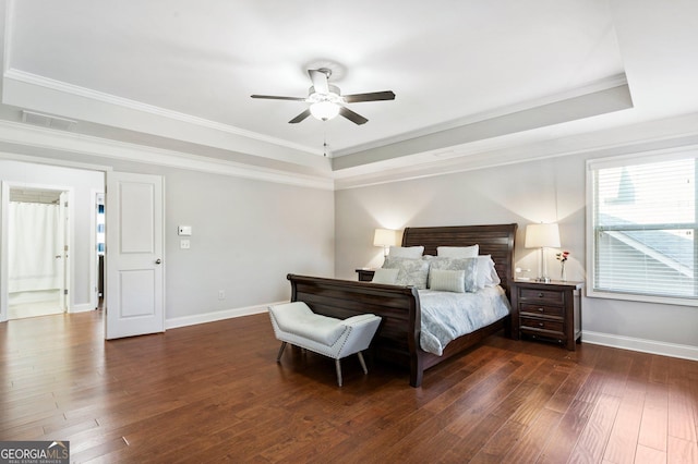 bedroom featuring a raised ceiling, ceiling fan, dark hardwood / wood-style floors, and ornamental molding